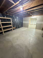 View of unfinished basement behind pocket doors in the Family Room