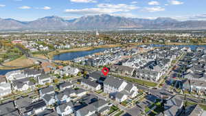 Aerial view of property's location with a water and mountain view and nearby suburban area