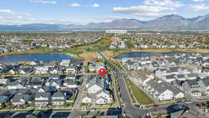 Aerial overview of property's location featuring a water and mountain view and nearby suburban area