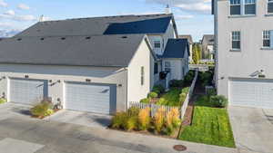 View of property exterior featuring stucco siding, a garage, and driveway