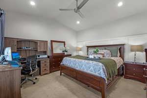 Bedroom featuring light colored carpet, an office area, lofted ceiling, ceiling fan, and recessed lighting