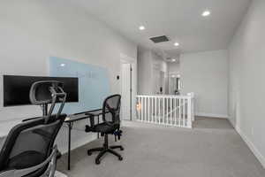 Office space with recessed lighting, light carpet, and attic access