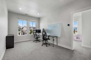 Office area with carpet floors, healthy amount of natural light, and recessed lighting
