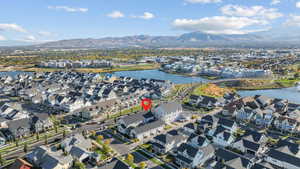 Aerial overview of property's location featuring a water and mountain view and nearby suburban area