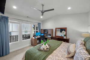 Carpeted bedroom with lofted ceiling, ceiling fan, and recessed lighting