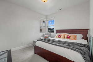 Bedroom with baseboards and carpet floors