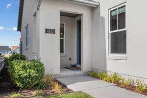 Entrance to property featuring stucco siding