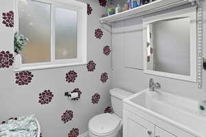 Bathroom featuring vanity and toilet