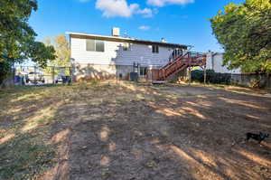 Back of house with stairway and a wooden deck