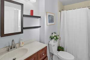 Bathroom with vanity and a shower with shower curtain