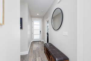 Doorway to outside featuring wood finished floors and recessed lighting