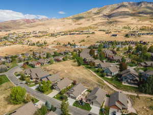 Aerial view of property's location featuring a mountain backdrop and nearby suburban area