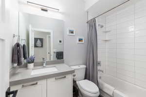 Full bath featuring shower / bathtub combination with curtain and vanity
