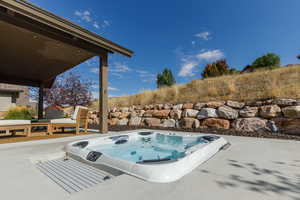 View of swimming pool featuring a patio area and an outdoor hot tub