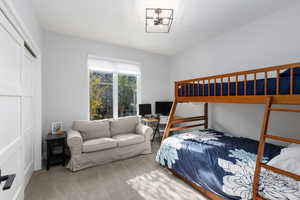 Bedroom featuring carpet, a closet, and a desk