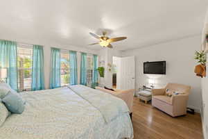 Bedroom featuring wood finished floors, ceiling fan, and a textured ceiling