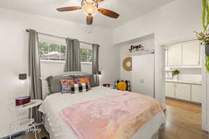 Bedroom with a ceiling fan, light wood-type flooring, and a closet