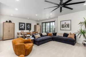 Carpeted living room featuring recessed lighting and a ceiling fan