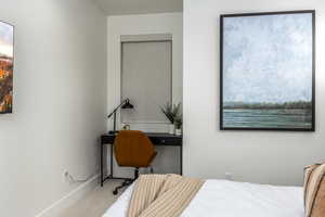 Bedroom with multiple windows and carpet