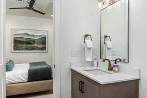 Ensuite bathroom with vanity and ceiling fan