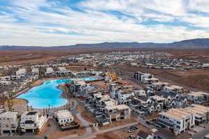 Aerial view of residential area featuring a mountainous background and a pool area