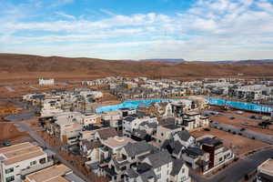 Aerial view of residential area featuring a pool and mountains