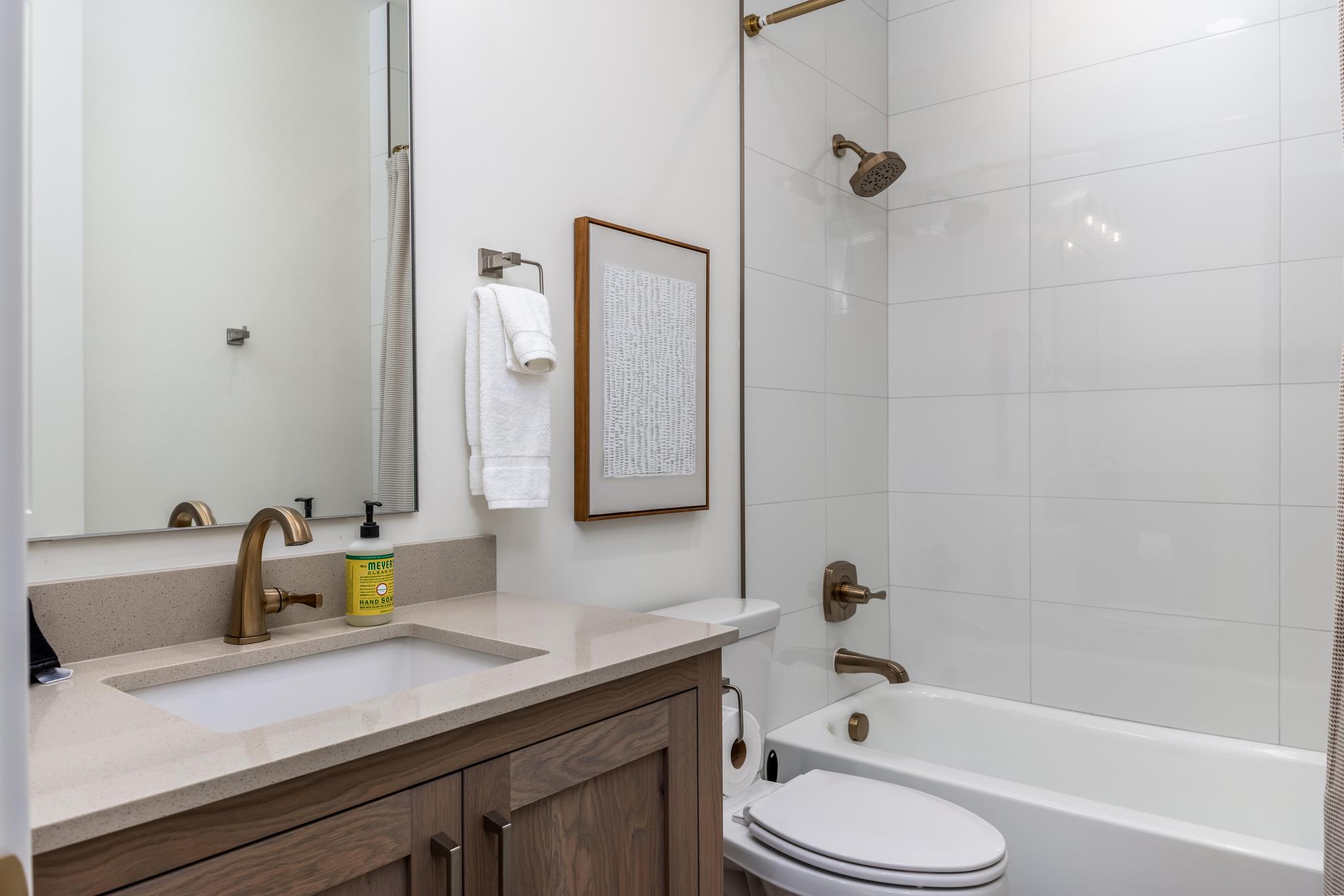 Bathroom featuring  shower combination and vanity