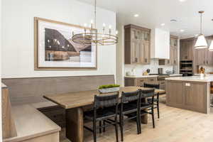 Dining space with light wood-style flooring, a chandelier, and recessed lighting