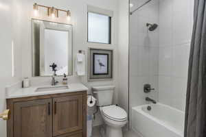 Bathroom with shower / bathtub combination with curtain and vanity
