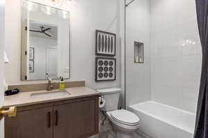 Full bath featuring vanity, shower / bath combination, and a ceiling fan