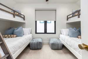 Carpeted bedroom featuring vaulted ceiling