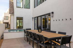 View of patio / terrace featuring outdoor dining space and a hot tub