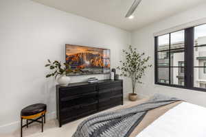 Carpeted bedroom with baseboards and recessed lighting