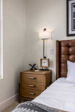 Bedroom featuring carpet floors and baseboards