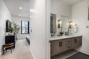 Ensuite bathroom with double vanity and recessed lighting