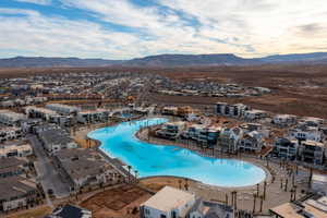 Aerial view of residential area featuring a pool area and mountains