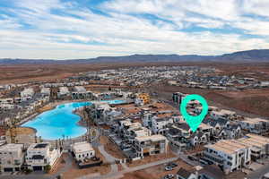 Aerial view of residential area with a mountainous background and a pool area
