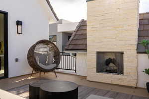 Sitting room with carpet and an outdoor stone fireplace
