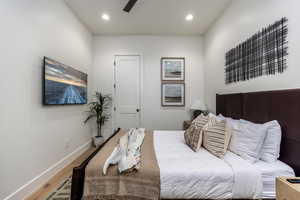 Bedroom with wood finished floors, recessed lighting, and a ceiling fan