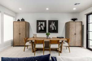 Dining space featuring light carpet and recessed lighting