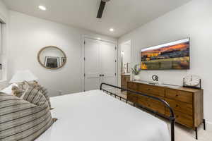 Bedroom with recessed lighting, a ceiling fan, a closet, connected bathroom, and carpet floors