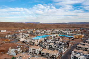 Aerial perspective of suburban area with a mountain backdrop and a pool area