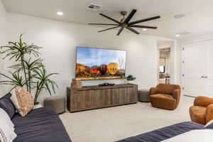 Living room featuring carpet flooring, recessed lighting, and ceiling fan