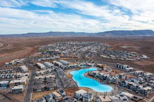 Aerial view of residential area featuring mountains and a pool