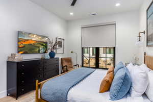 Bedroom with wood finished floors, recessed lighting, and ceiling fan
