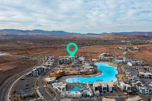 Aerial view of property's location featuring a mountain backdrop and a pool area