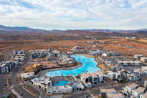Aerial overview of property's location featuring a pool area and a mountainous background