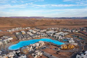 Aerial view of residential area with a pool and a mountain backdrop