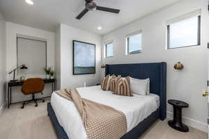 Carpeted bedroom with ceiling fan, recessed lighting, and a desk