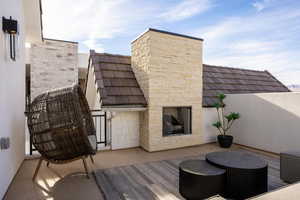 View of patio / terrace featuring an outdoor stone fireplace